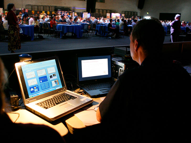 Man sitting with two laptops