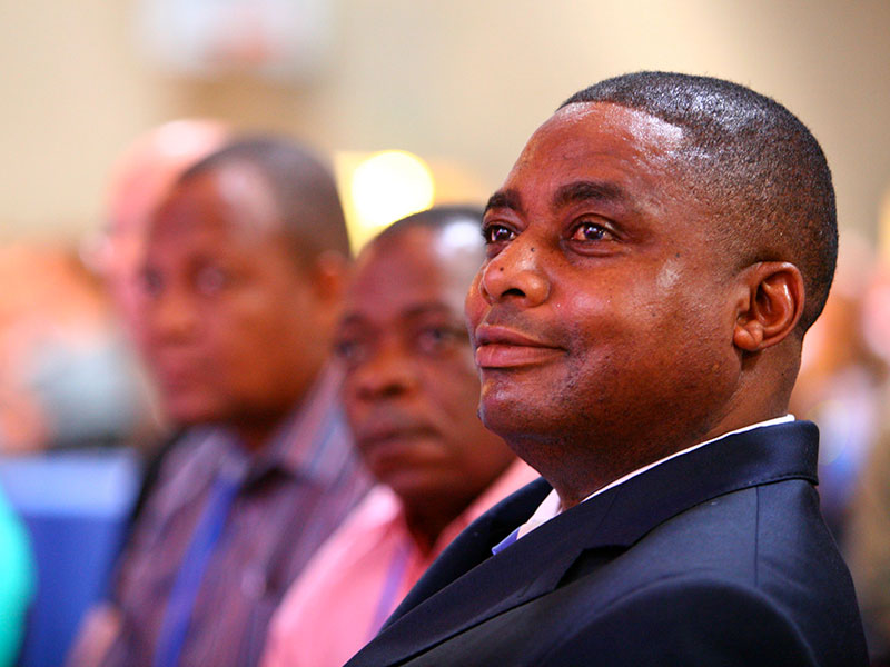 Close up of a person sat in an audience row with three other people sat alongside them