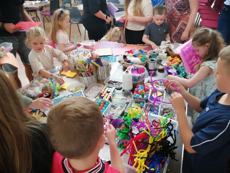 Children playing with colouring pens and arts and crafts.